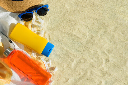 Beach Essentials with Hat, Sunglasses, Sunscreen and Water Bottle. Summer Vacation Flatlay