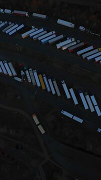 Vertical Screen Dense Trailer Cluster Causing Supply Delays With Packed Rows Of Trailers In Depot, Aerial Shot Highlights Congestion, Bottlenecked Lanes And Tense Industrial Atmosphere