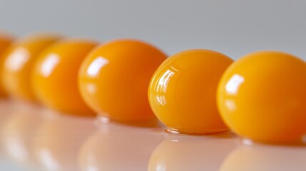 Bright yellow egg yolks aligned on a reflective surface, representing protein and nutrition
