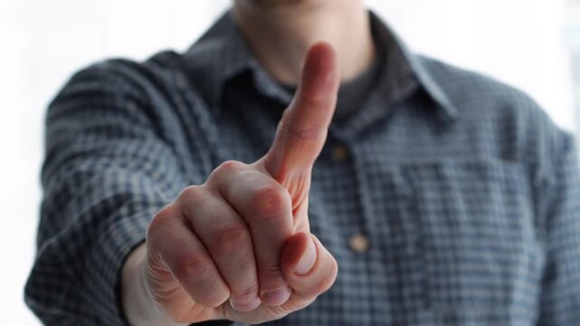 A categorical finger gesture.
A man swipes his finger, demonstrating his principled nature.