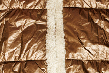 Quilted gold jacket fabric with fleece lining © Iryna Miadzvedzeva