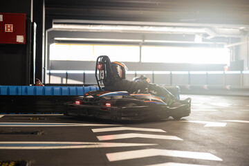 A go-kart drifts around a corner, capturing the essence of speed and control in indoor racing. © Dejan