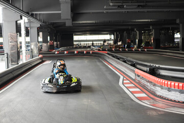 An interior view capturing the essence of go-karting as racers tackle sharp turns on the track.