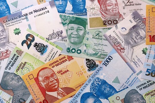 Nigeria naira money bills pile on table. Nigeria banknotes of NGN currency close up
