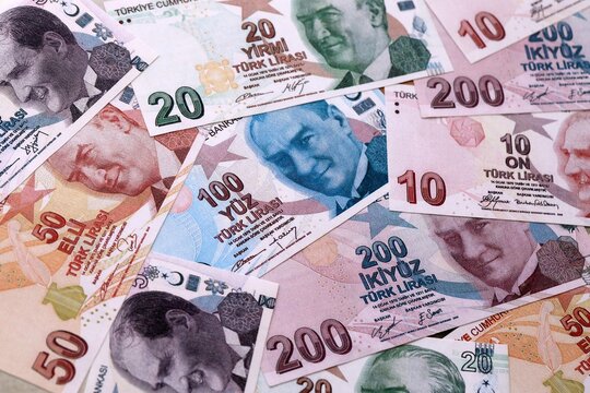 Turkish lira money bills pile on table. Turkey banknotes of TRY currency close up. Concept of business, economy and investment in Turkey