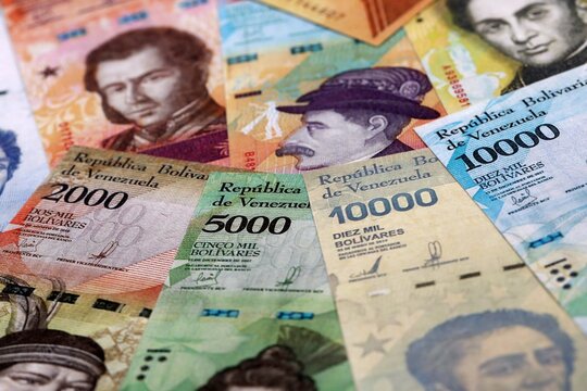 Venezuelan bolivar money bills pile on table. Venezuela banknotes of VES currency close up