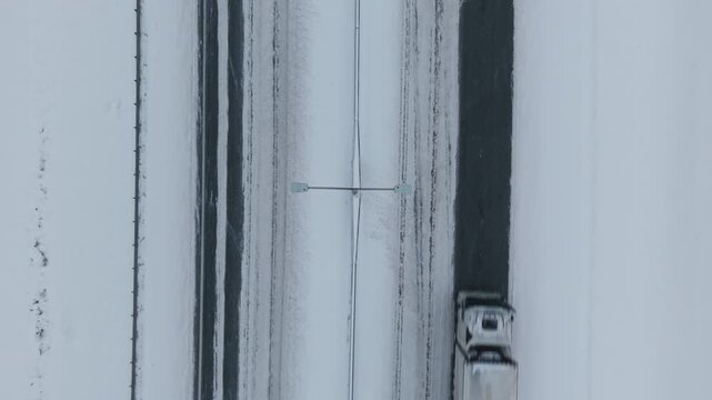 Serene winter road transport ensuring continuous supply chain across open European scenery