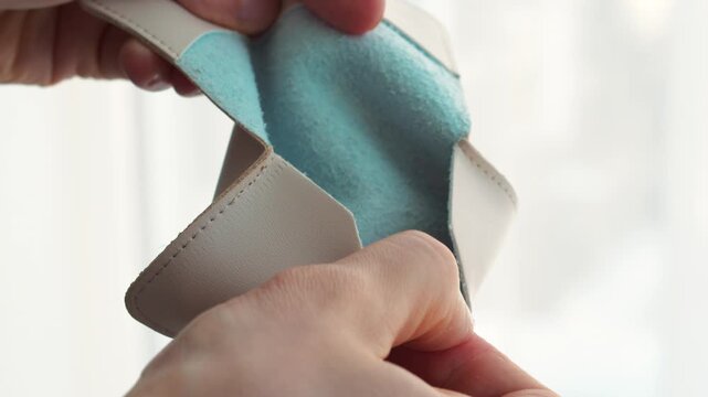 A man opens his empty wallet and gets angry that he has no money.
A wallet without money