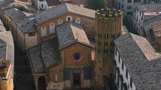 Aerial tilt-up and pull-back from Church of San Giovenale and Torre Dodecagonale to Orvieto historic center. Drone reveal of medieval town on tuff cliff at sunrise Umbria Italy. 4K cinematic 10bit Hdr