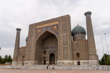 Fototapeta premium JUNE 23,2023, SAMARKAND, UZBEKISTAN: The Registan, the heart of the ancient city of Samarkand - Uzbekistan. Dramatic sunset sky, copy space for text, wide angle lens shot