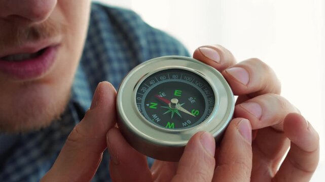 A compass in a person's hands.
A compass for determining direction while traveling.
Direction of travel