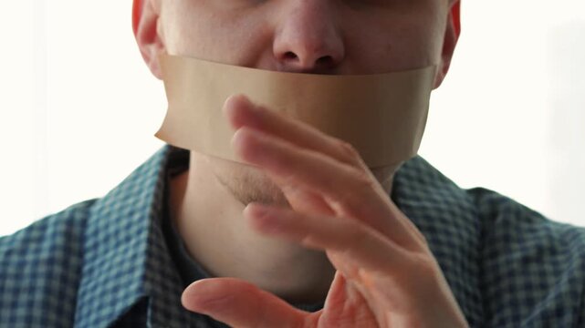 Silence and silence.
A mouth sealed with tape.
A man keeps a secret.
Conservation and silence