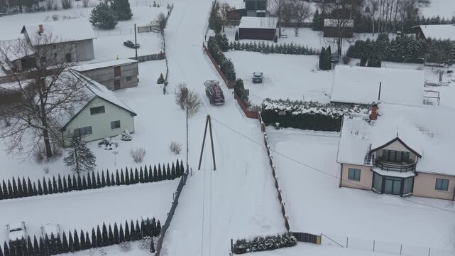 Village road with houses and snow cover. Serene winter scene of rural lane with mailboxes and fences