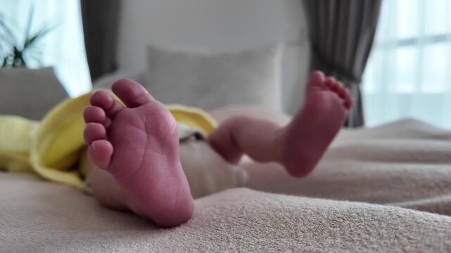 Newborn baby feet in motion symbolizing early childhood growth and reflex development. Family lifestyle concept