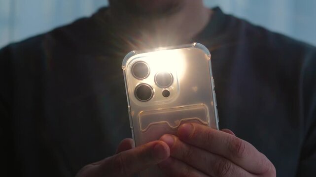 A close-up of a bright flash on a mobile phone.
Flashlight on the phone