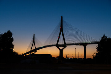 Obraz premium Cable-stayed bridge silhouette at dusk, Cádiz, Spain