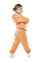 Fashion. Cute little girl in stylish outfit on white background