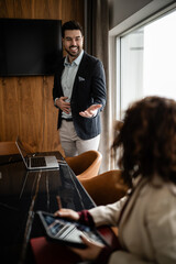 Businessman giving presentation in professional office meeting