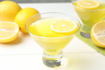 Tasty lemon jelly on white wooden table, closeup