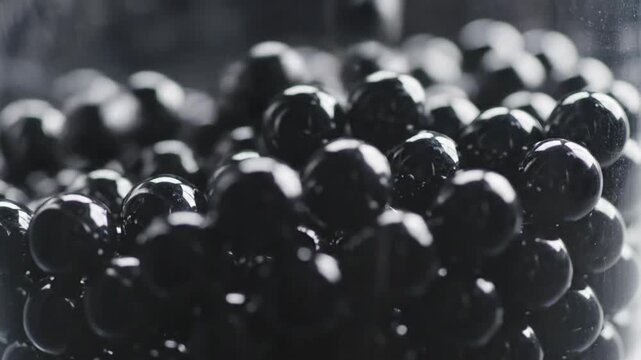 Close-up of shiny black tapioca pearls in glass