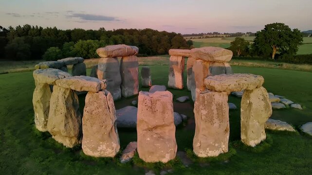 Explore ancient stones at Stonehenge during sunset over the English landscape