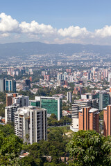 Fototapeta premium Guatemala City skyline beneath volcanic peaks