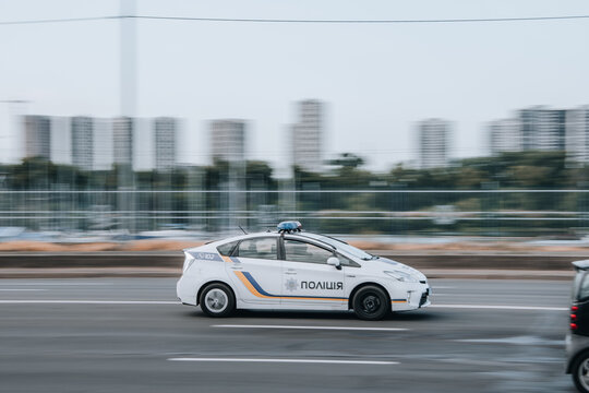Ukraine, Kyiv - 29 July 2021: White Toyota Prius Patrol Police car moving on the street. Editorial