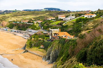 Naklejka premium Rocky coastline and sandy beach with cliffs and ocean waves. High quality photo