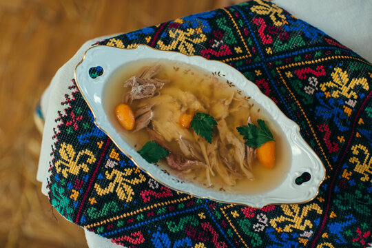 Traditional ukrainian holodets serving on embroidered fabric