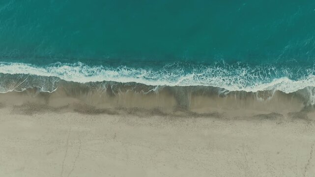 Calm sea waves crash on the beautiful sandy Italian coast overhead nature