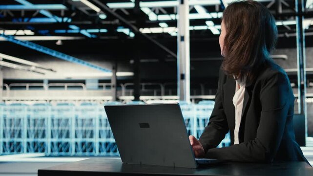 Optimizing server, laptop and software developer in data center doing load balancing. Adjusting system parameters, notebook and woman in server farm at desk improving efficiency, camera A