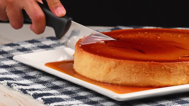 Kitchen knife slicing a creamy homemade egg flan