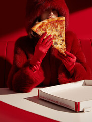 woman in red coat holding a pizza