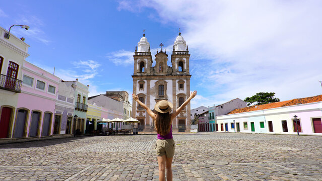 Tourist woman with open arms in the historic center of Recife, Brazil
