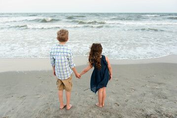 Naklejka premium Two children looking at the ocean 