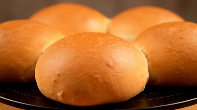 Freshly Baked Golden Dinner Rolls or Bread Buns Arranged on a Serving Platter. Close-up Shot of Soft, Fluffy Brioche or Milk Bread Rolls Ready for Consumption.