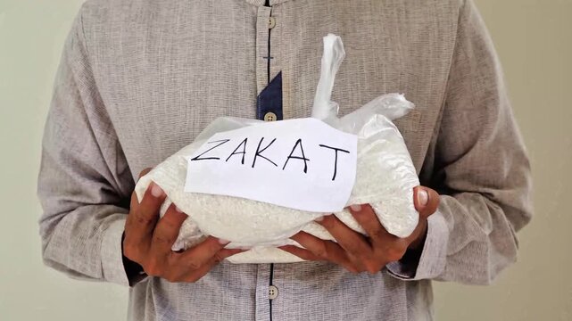 Muslim man receives zakat fitrah rice
