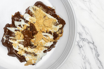 Cinnamon Donut Covered in Dark Chocolate with Vanilla Glaze  Graham Craker and Melted Chocolate Bar