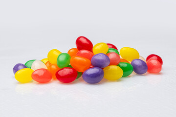 Closeup of a Pile of Brightly Colored Jellybeans on a White Background