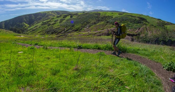Hikers Walking Along Winding Trail Through Rolling Green Hills on Santa Cruz Island, Channel Islands National Park, California Timelapse