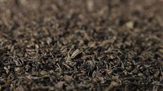 Pile of dried tea leaves as background, closeup