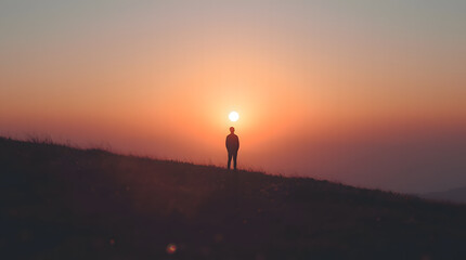 Fototapeta premium silhouette of a man on a mountain top