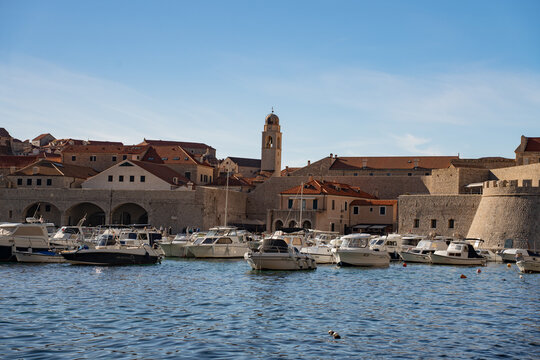 Dubrovnik Croatia aerial view of historic old town harbour port with yachts and fortress.
