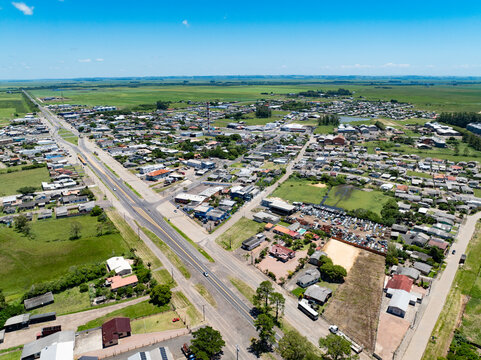 Aerial view of Capivari do Sul town and highway, Rio Grande do Sul, Brazil, small cityscape in rural landscape