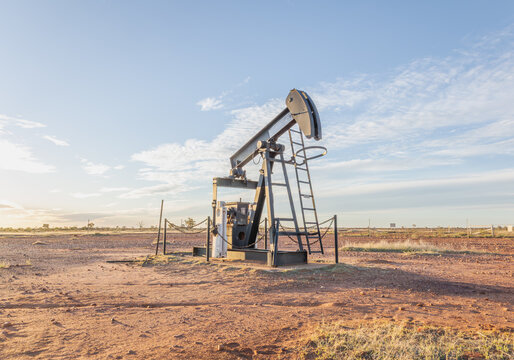 An oil pump or nodding donkey probably used to bring water rather than oil to the surface in this case, stands, no longer in use, on the flat semi-arid plains at Thargomindah in Queensland, Australia.
