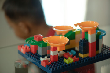 Child admires vibrant lego marble run creative play, education, childhood development, toy store marketing, childcare blogs, parenting websites. © Mr