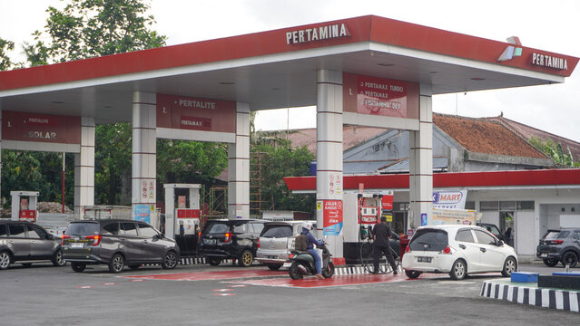 The situation at the pertamina gas station or spbu saw lots of cars and trucks queuing up to refuel. A filling station, also known as petrol or gas station. Car, truck, motorcycle. Boyolali, Indonesia