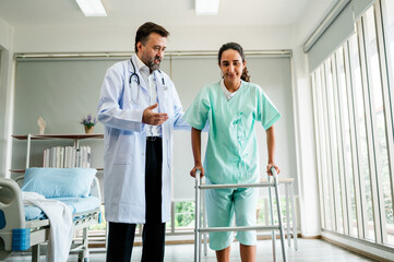 doctor is helping a woman with a walker