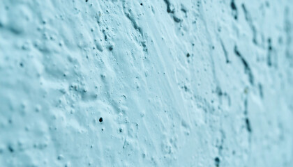 Abstract close-up of light blue rough textured stucco wall surface creating a bumpy background pattern with shallow depth of field and copy space © Adrian Syauqi