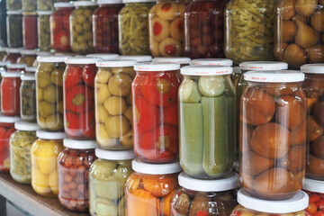 Jars filled with pickled vegetables in a market display